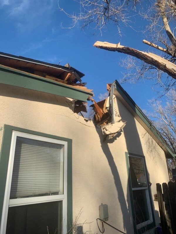 Roof Destruction Caused by a Falling Tree During a Severe Weather Event